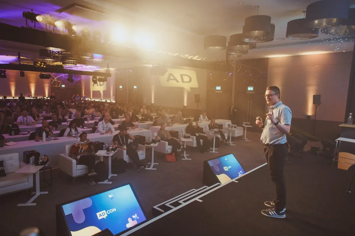 Paul Green speaking to the audience at AdCon