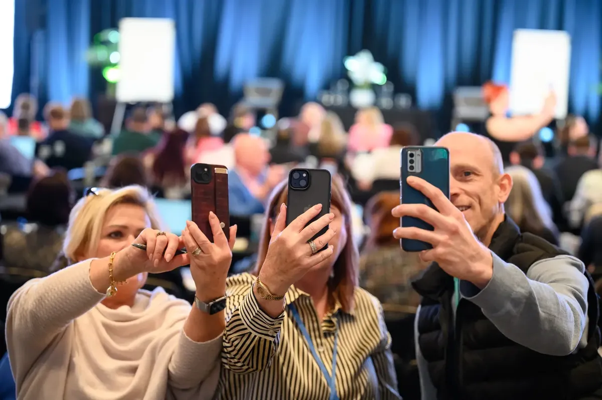 Event audience scanning a QR code with their phones