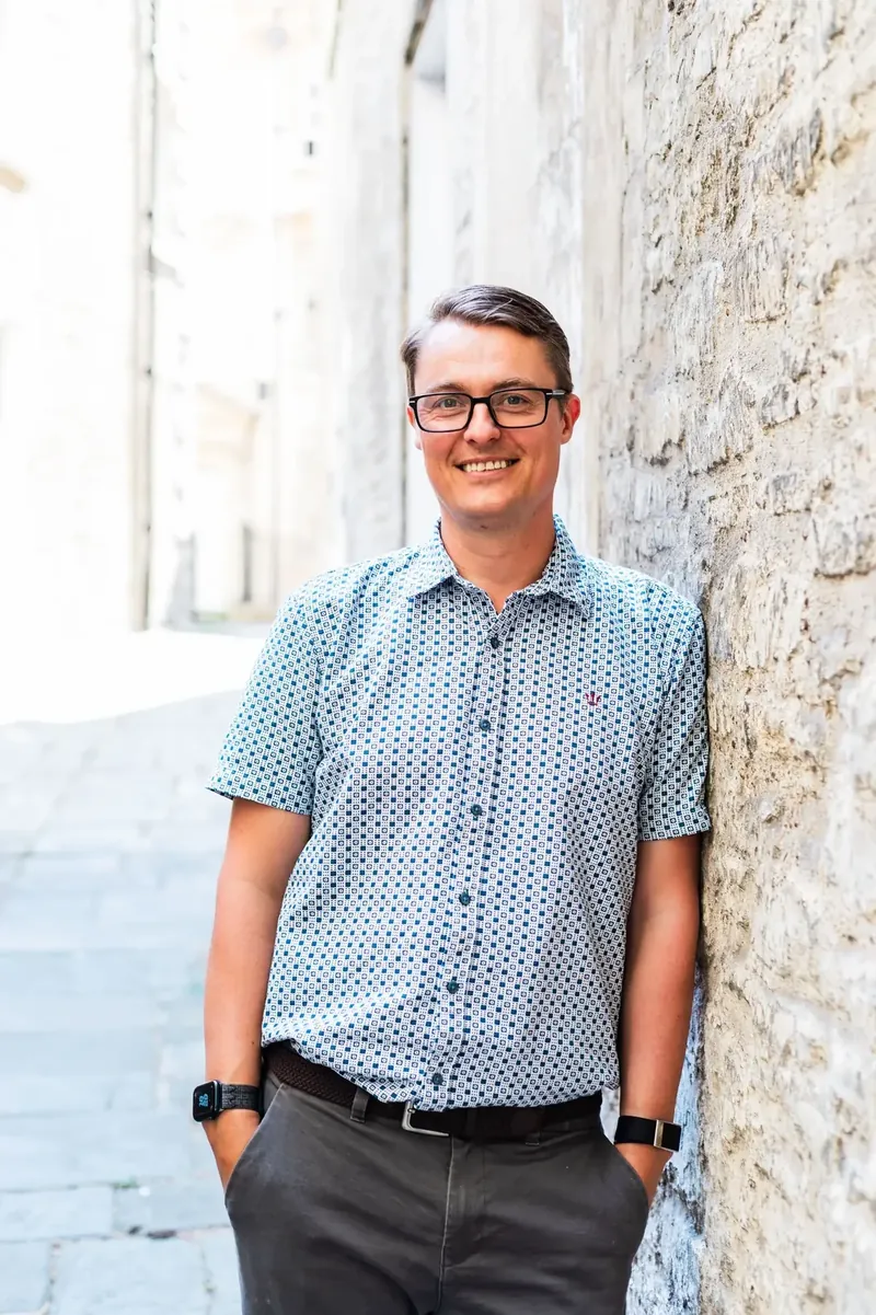 Paul Green, founder of Client Funnels, beside a Bath stone wall